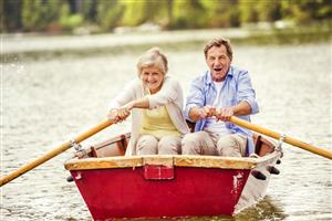 Senior couple rowing a boat.